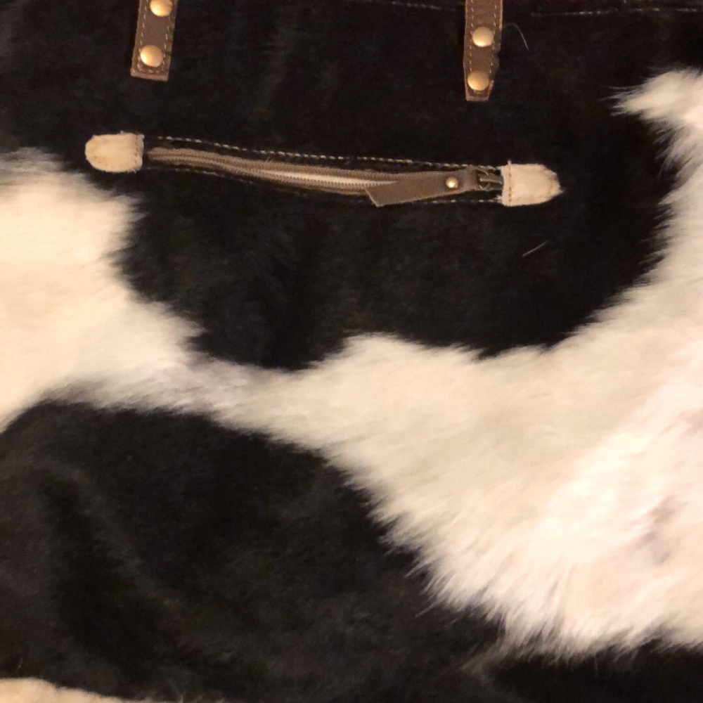 This is cowhide over size purse it’s 17 wide 16 Long